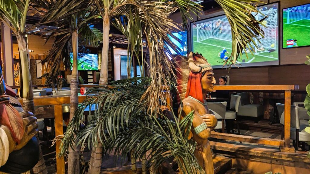 Big-screen TVs showing live sports above the bar at Arizona Grill Lounge in Etobicoke